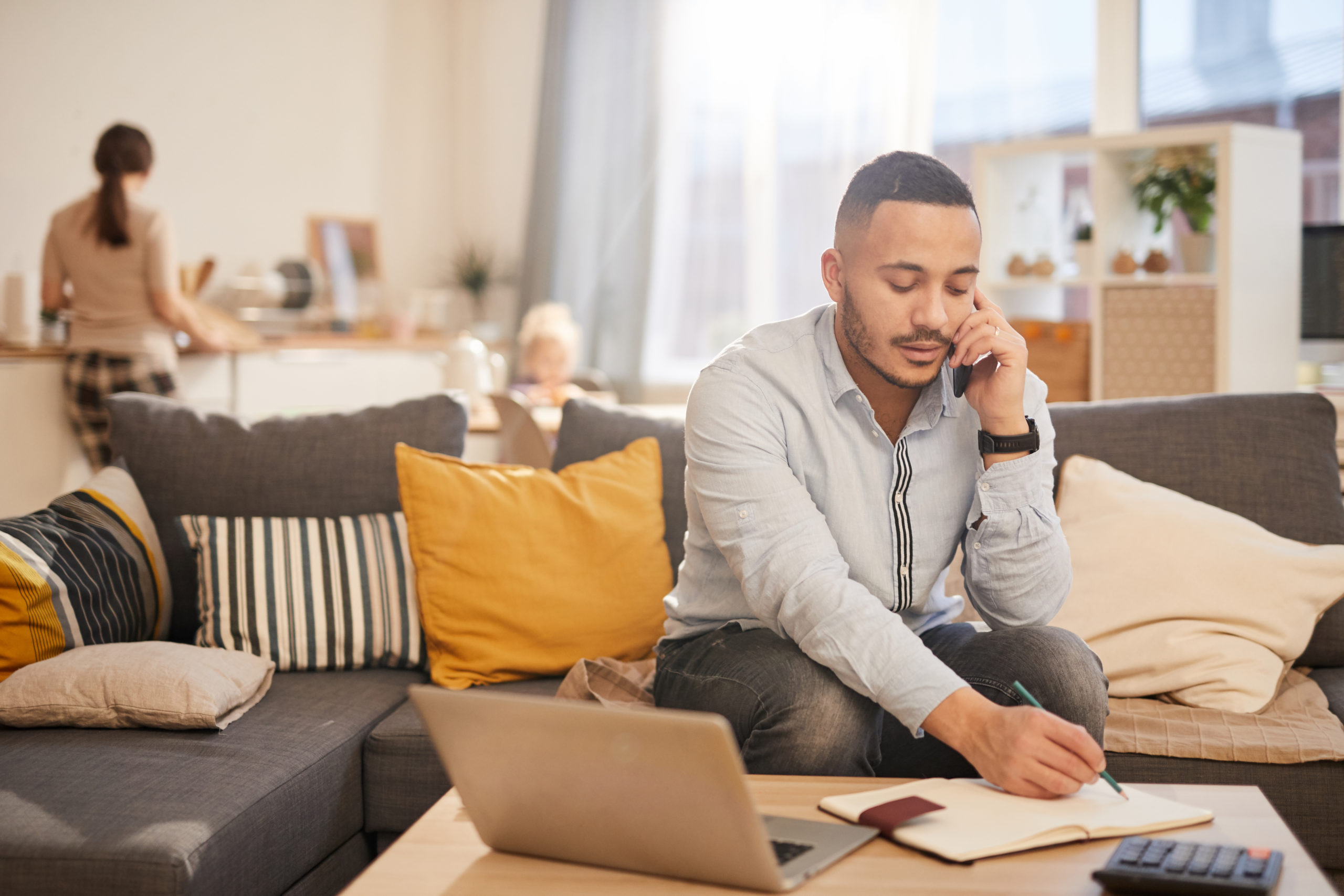 man on the phone using notebook