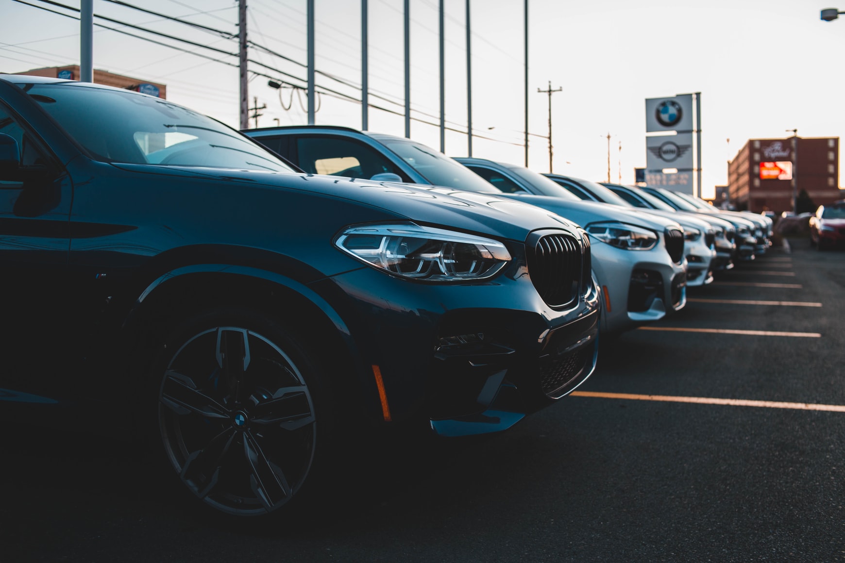 cars parked in front of a dealership