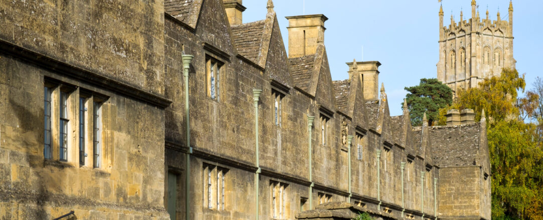 Autumn sunshine on the picturesque row of almshouses in Chipping Campden, a Cotswolds travel destination, Gloucestershire,  UK
