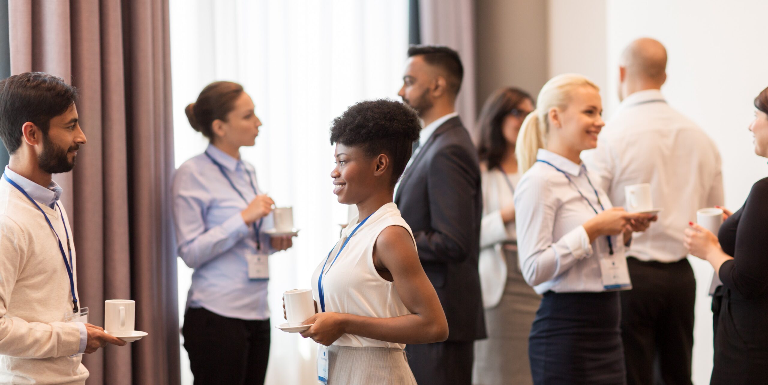 business people with conference badges and coffee